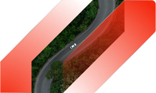A white car driving on a winding road surrounded by green trees, overlaid with red geometric shapes.
